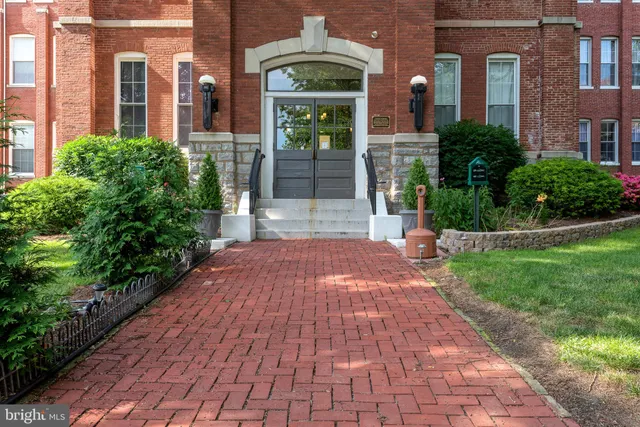 a view of a brick building next to a yard