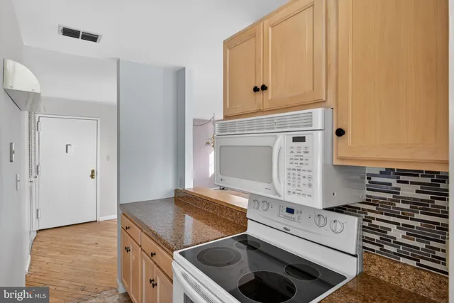 a kitchen with a stove and a microwave