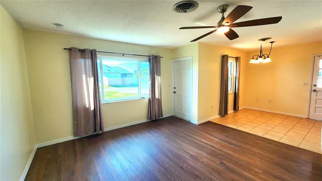 a bathroom with a granite countertop bathtub sink vanity mirror and toilet