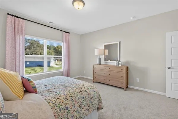 a bedroom with a bed and a dresser