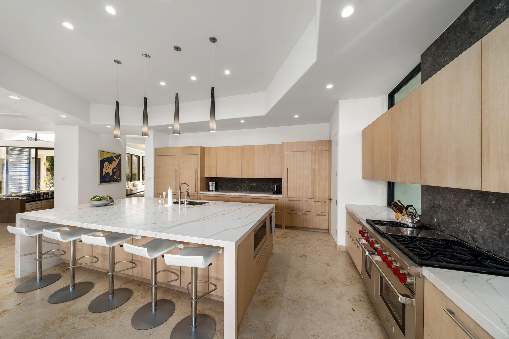 178 Netas Drive Palm Desert, CA 92260 - Photo 14 of 83 a kitchen with a stove a sink a kitchen island and chairs in it