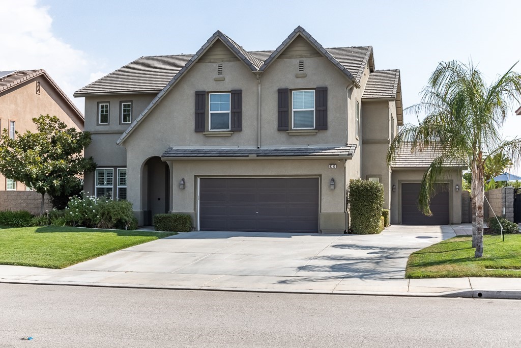 8262 Laurel Ridge Road Riverside, CA 92508 - Photo 1 of 1 a front view of a house with a yard and garage