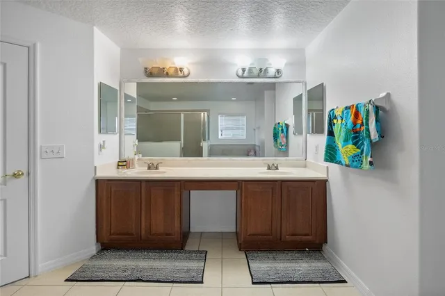 a bathroom with a sink double vanity and a mirror