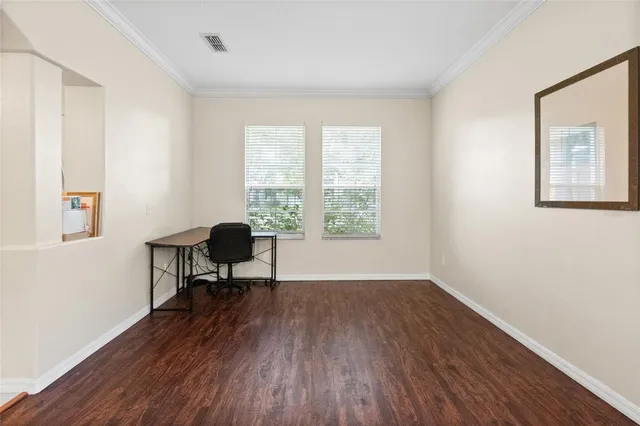 a work room with wooden floor and a window
