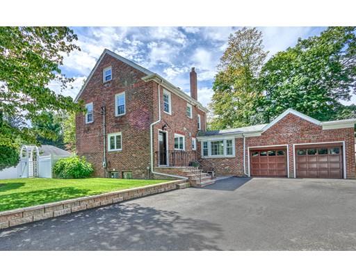 5 Grassmere Road Brookline, MA 02467 - Photo 11 of 12 a view of a yard in front of a brick house with large windows