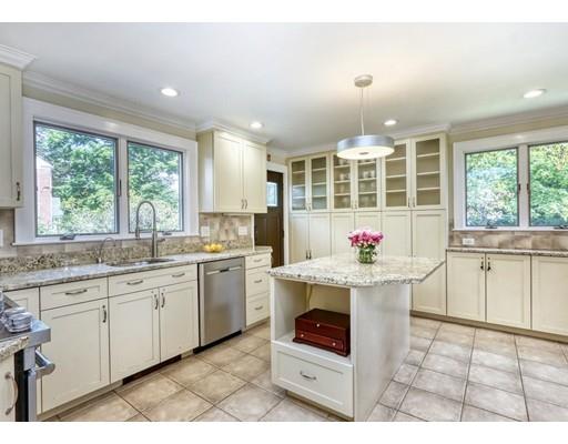 5 Grassmere Road Brookline, MA 02467 - Photo 4 of 12 a kitchen with granite countertop a stove a sink dishwasher a dining table and chair with wooden floor