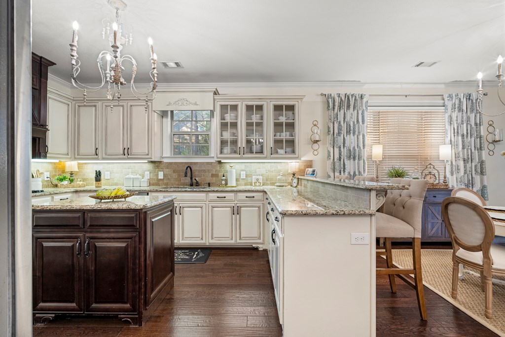 8014 Splendor Way Columbus, GA 31904 - Photo 22 of 58 a kitchen with granite countertop white cabinets and wooden floor