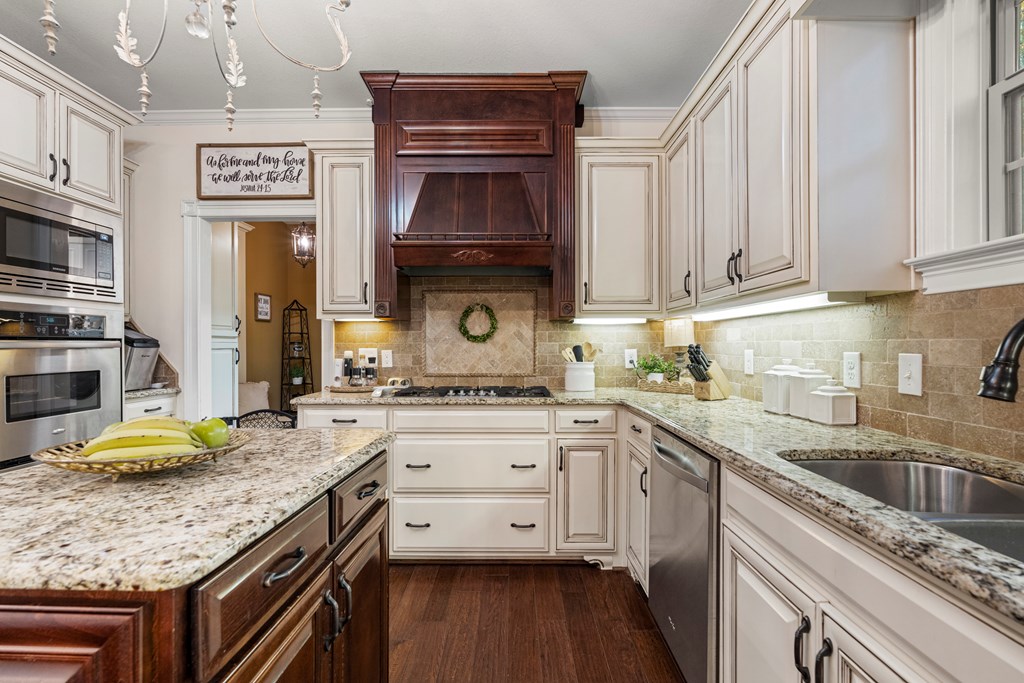 8014 Splendor Way Columbus, GA 31904 - Photo 24 of 58 a kitchen with stainless steel appliances granite countertop a stove sink and cabinets