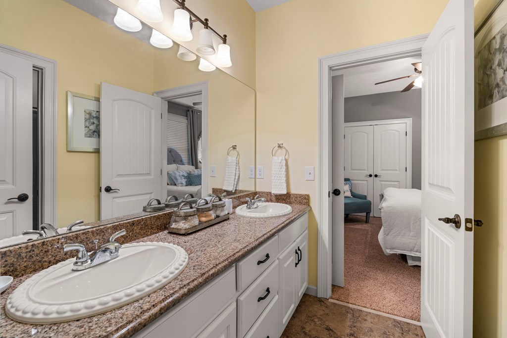8014 Splendor Way Columbus, GA 31904 - Photo 37 of 58 a bathroom with a granite countertop sink a toilet and a mirror