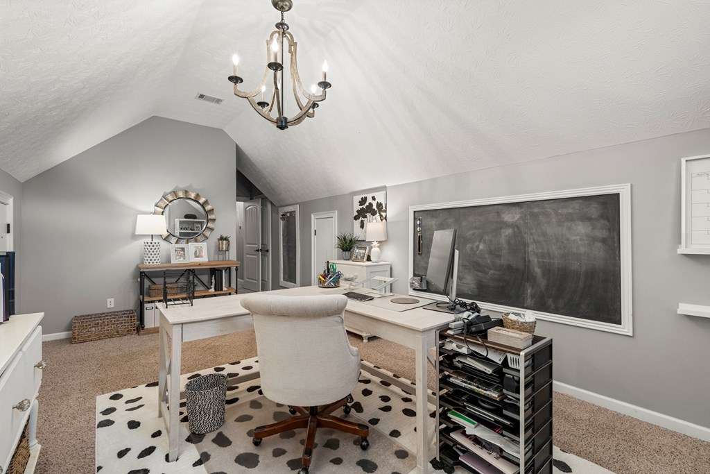 8014 Splendor Way Columbus, GA 31904 - Photo 43 of 58 a living room with furniture a chandelier and a flat screen tv