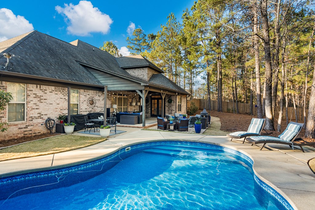 8014 Splendor Way Columbus, GA 31904 - Photo 50 of 58 a view of a backyard with a patio and outdoor seating