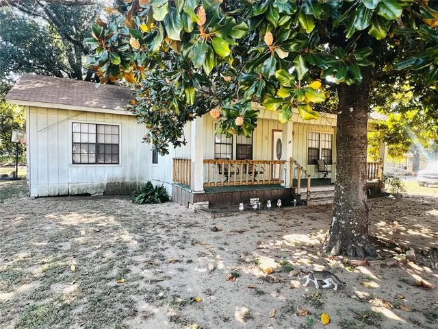 a backyard of a house with yard and outdoor seating