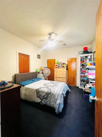 a bedroom with a bed and a desk