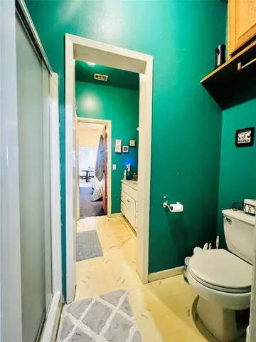 a bathroom with a toilet and a sink