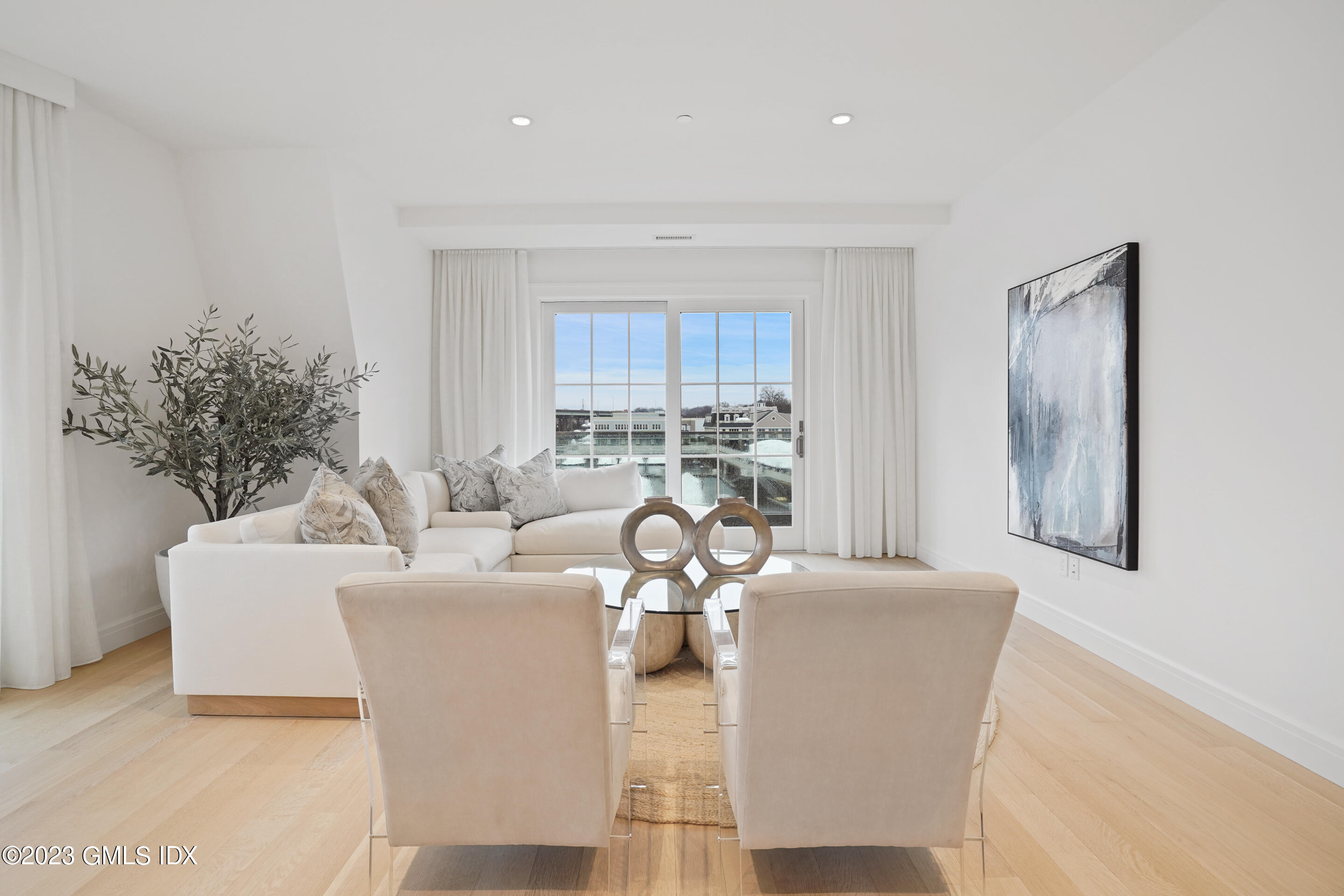 89 River Road, Unit 206 Cos Cob, CT 06807 - Photo 3 of 22 a living room with fireplace furniture and a potted plant
