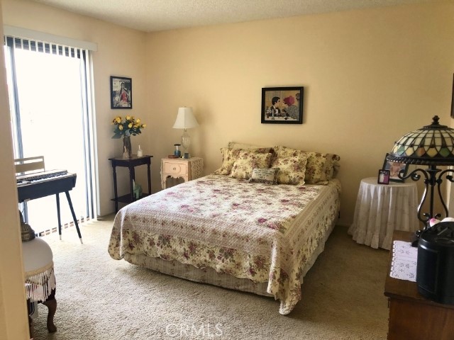 200 East Racquet Club Road, Unit 19 Palm Springs, CA 92262 - Photo 10 of 21 a bedroom with a bed and a table in it