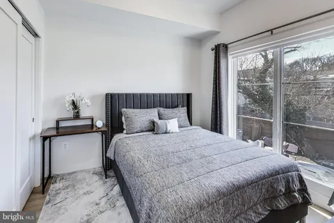 a bedroom with a bed and window