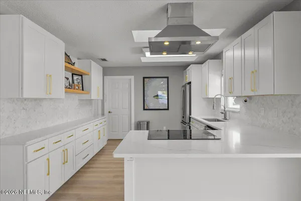 a spacious bathroom with a granite countertop sink a mirror and a