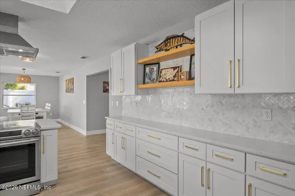 a bathroom with a granite countertop toilet a sink a shower and a mirror