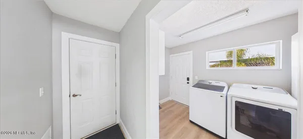 an aerial view of a house with swimming pool and lake view