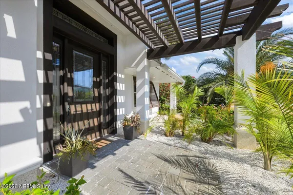 a view of a hallway with wooden floor and a living room