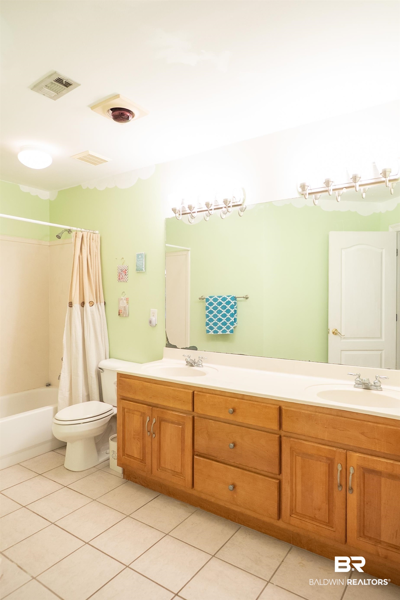 10023 Springfield Court Mobile, AL 36695 - Photo 28 of 50 Bathroom featuring double vanity, light tile patterned floors, and shower / tub combo