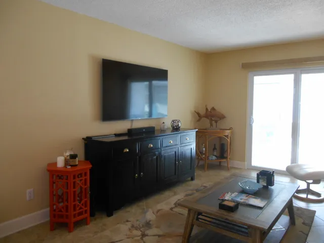 a view of a room with furniture and wooden floor