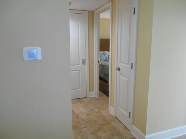 a view of a hallway with a livingroom and a bathroom sink