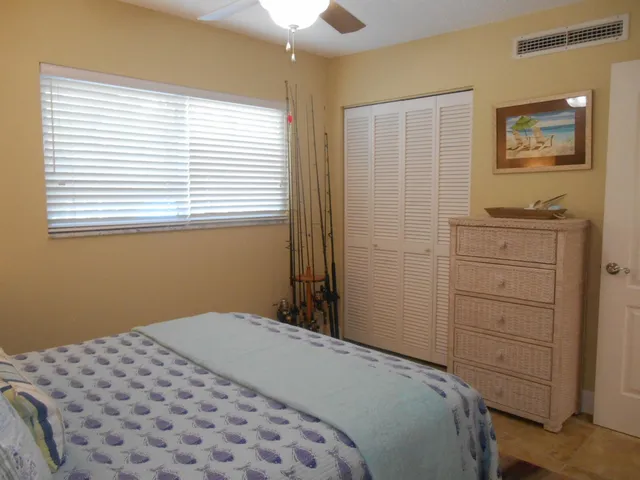 a spacious bedroom with a large bed and a chandelier