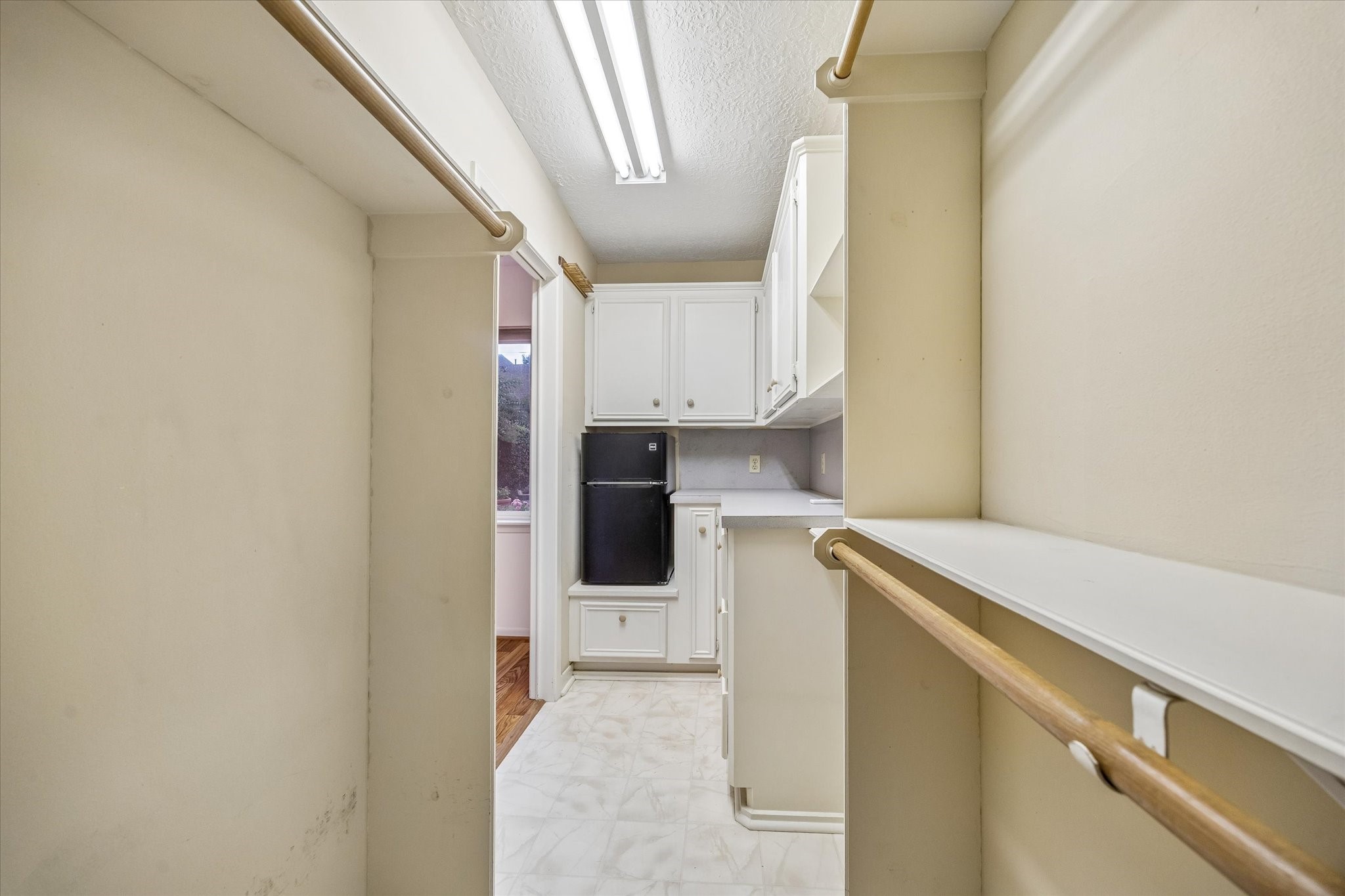 5515 Sylmar Road Houston, TX 77081 - Photo 23 of 28 The walk-in closet of third bedroom has loads of storage space with cabinets and enough room for a mini fridge!