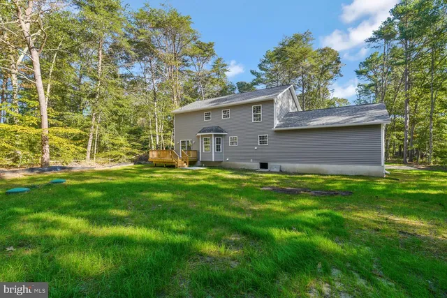a view of house with backyard