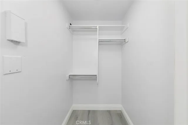 a view of walk in closet with clothes