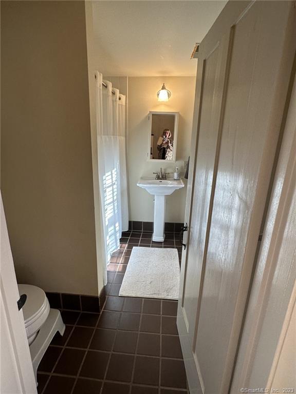 14 Quassuk Road, Unit 14 Woodbury, CT 06798 - Photo 17 of 23 a bathroom with a sink and mirror with toilet