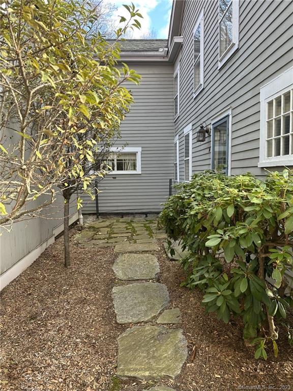 14 Quassuk Road, Unit 14 Woodbury, CT 06798 - Photo 3 of 23 a front view of a house with garden