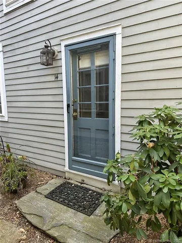 a view of a backyard with wooden fence and floor
