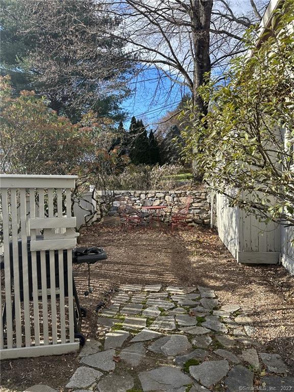 14 Quassuk Road, Unit 14 Woodbury, CT 06798 - Photo 5 of 23 a view of a backyard with wooden fence and floor