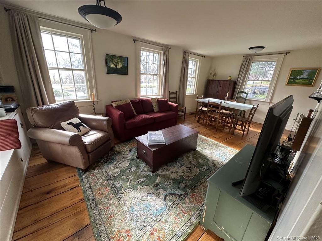 14 Quassuk Road, Unit 14 Woodbury, CT 06798 - Photo 7 of 23 a living room with furniture rug and window