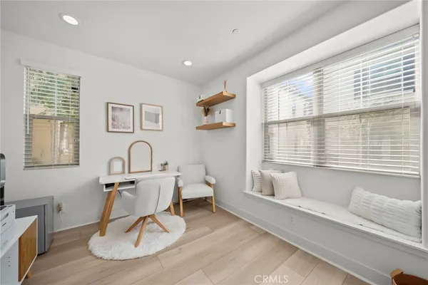 a white table sitting in a living room next to a window