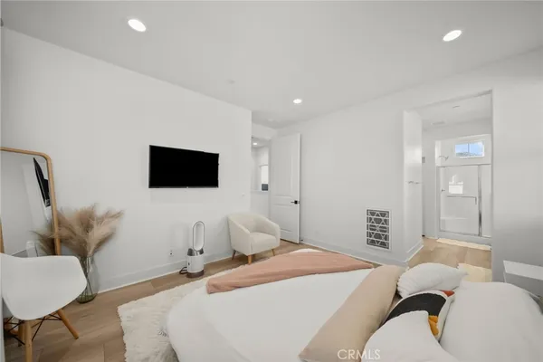 a bedroom with a bed and a flat screen tv