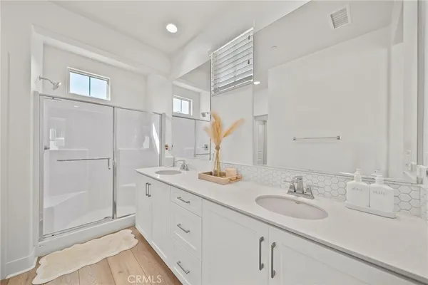 a bathroom with a sink double vanity and a mirror