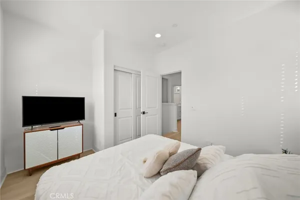 a bedroom with a flat screen tv and a bed