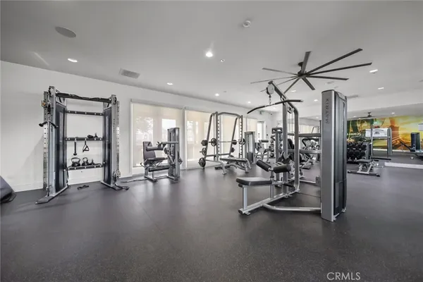 a view of a room with gym equipment and a large window
