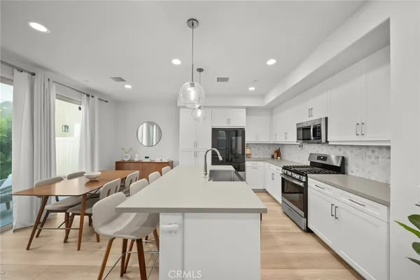 a kitchen with stainless steel appliances kitchen island granite countertop a sink and cabinets