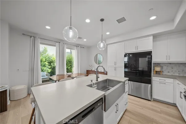 a kitchen with a stove a sink and a refrigerator