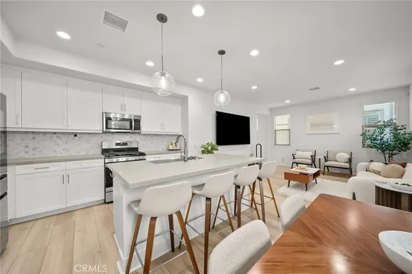 a view of kitchen with cabinets table and chairs