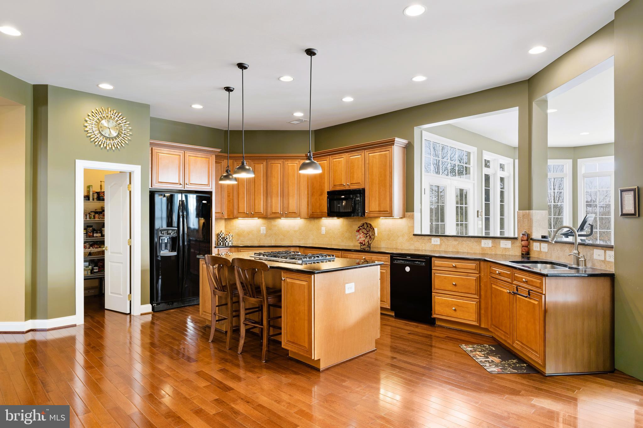 19606 Bellingham Lane Leesburg, VA 20175 - Photo 17 of 73 a large kitchen with stainless steel appliances granite countertop a stove and a refrigerator