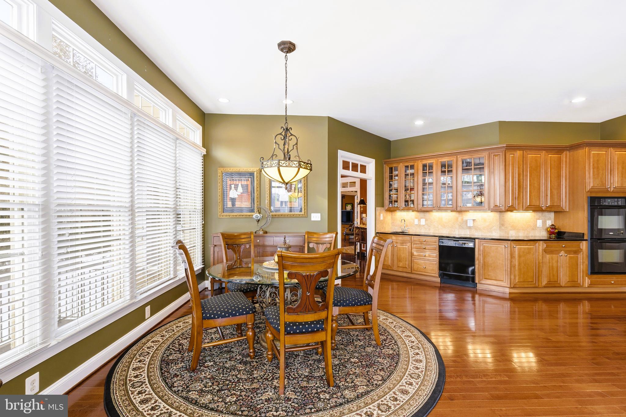 19606 Bellingham Lane Leesburg, VA 20175 - Photo 22 of 73 a dining room with furniture a chandelier and wooden floor