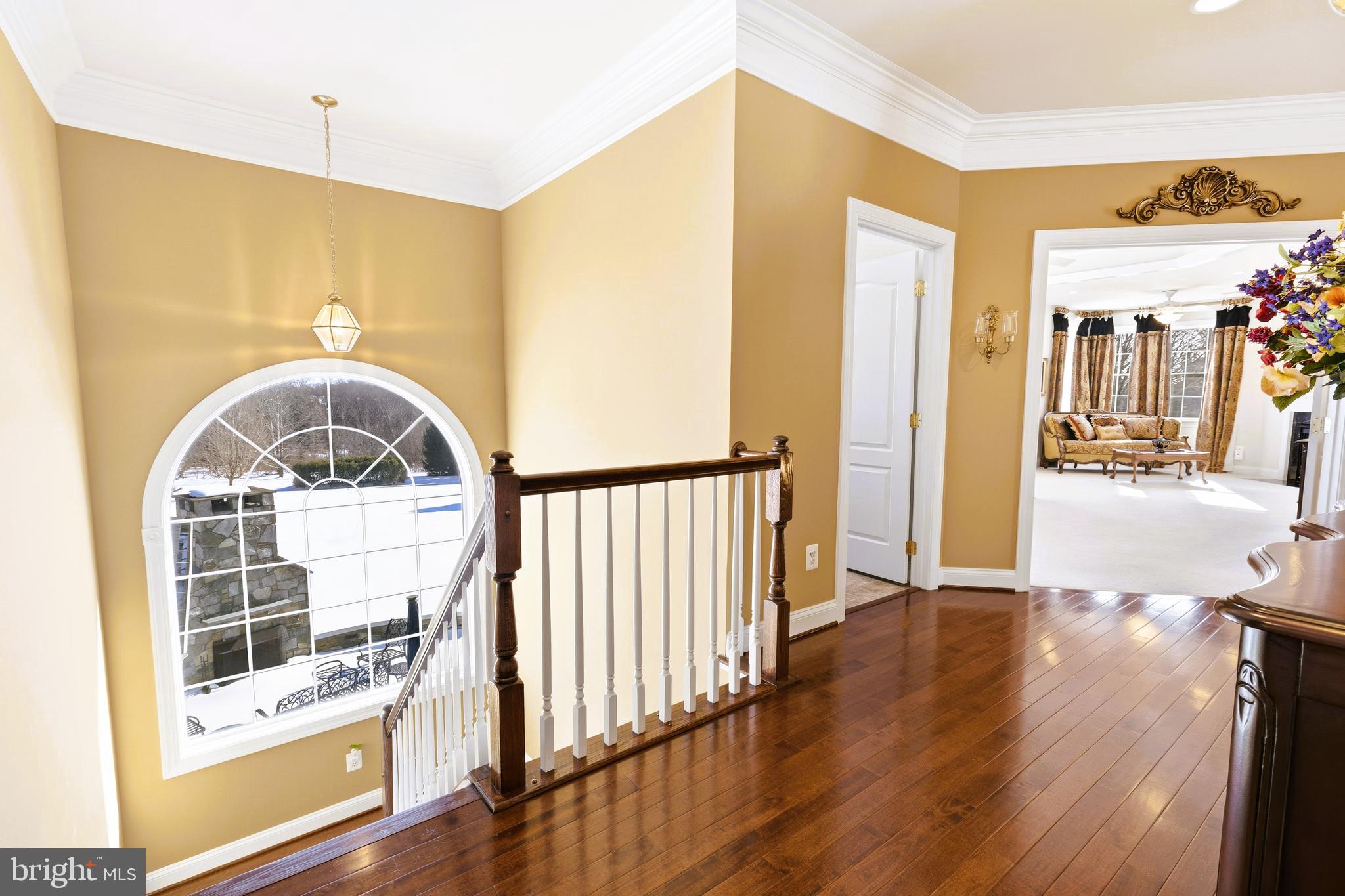 19606 Bellingham Lane Leesburg, VA 20175 - Photo 41 of 73 a view of a hallway with wooden floor and a living room