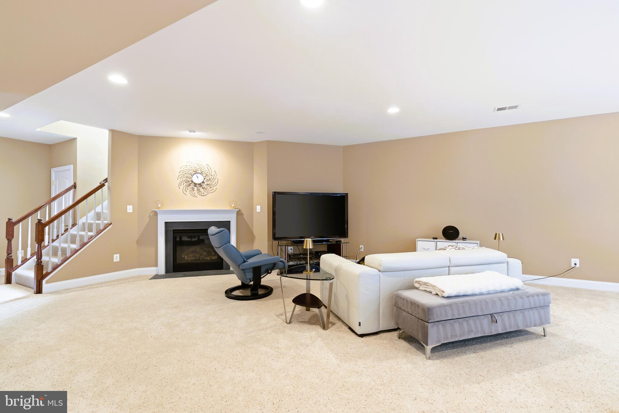 19606 Bellingham Lane Leesburg, VA 20175 - Photo 54 of 73 a living room with furniture fireplace and flat screen tv