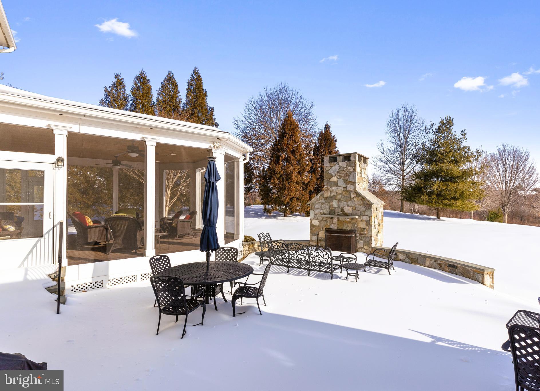 19606 Bellingham Lane Leesburg, VA 20175 - Photo 61 of 73 a view of a patio with a table and chairs and floor to ceiling window